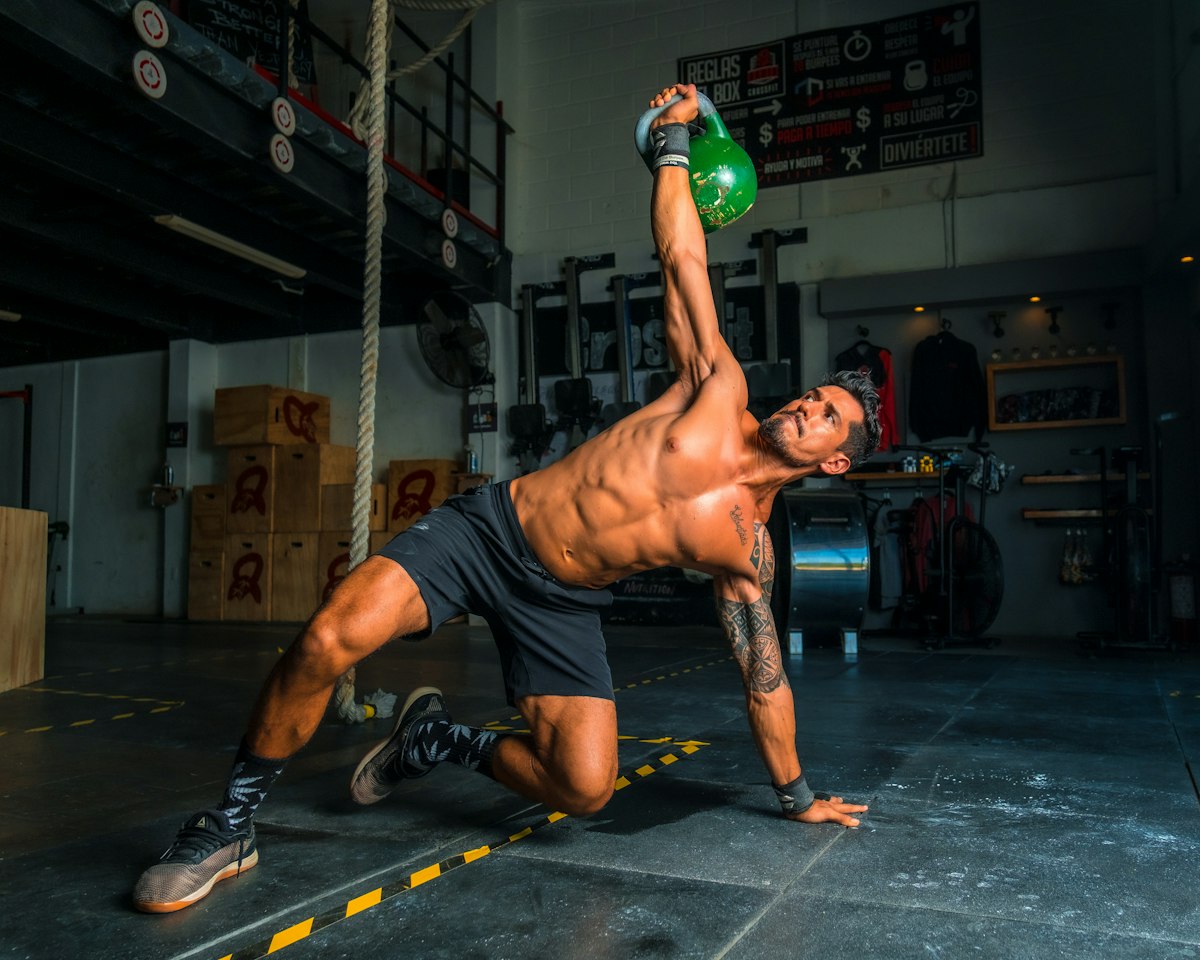 Athlete pressing a kettlebell overhead
