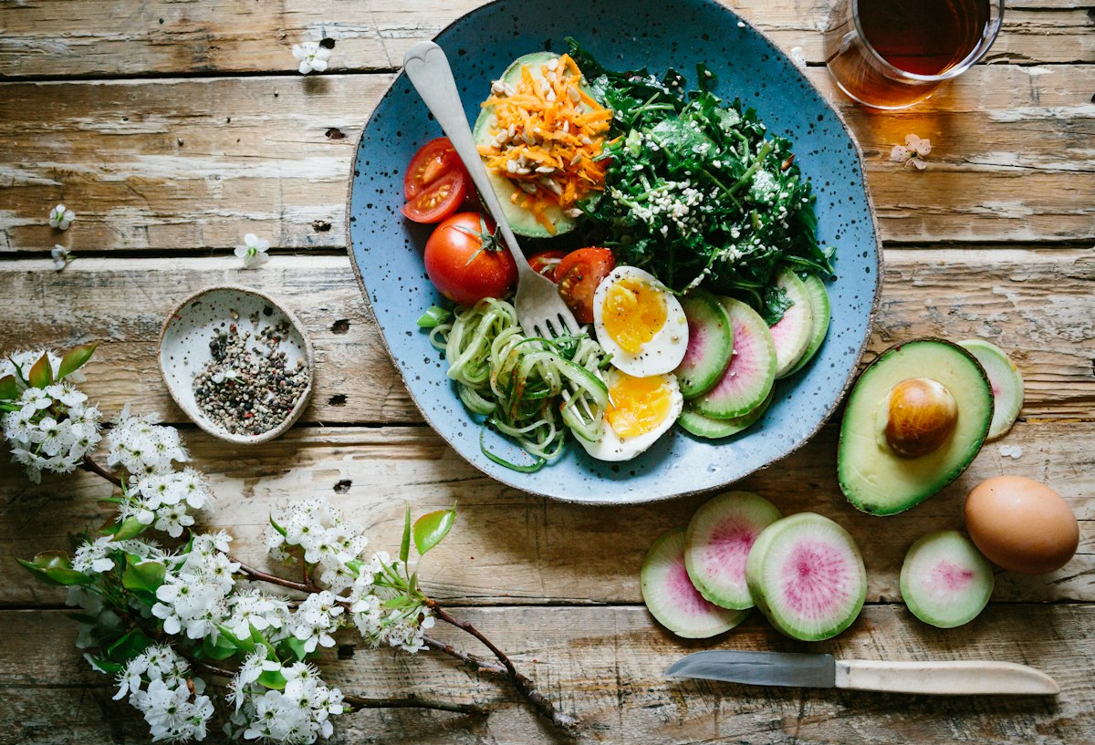 A colourful bowl of fresh vegetables, egg and avocado