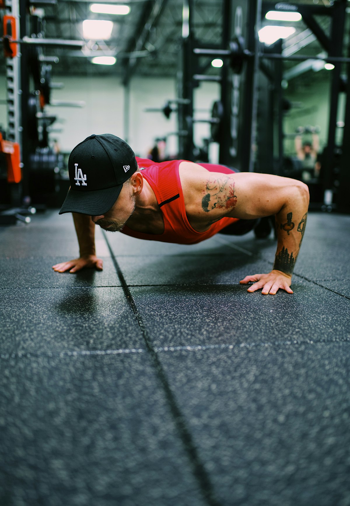 Athlete doing push-ups on a gym floor