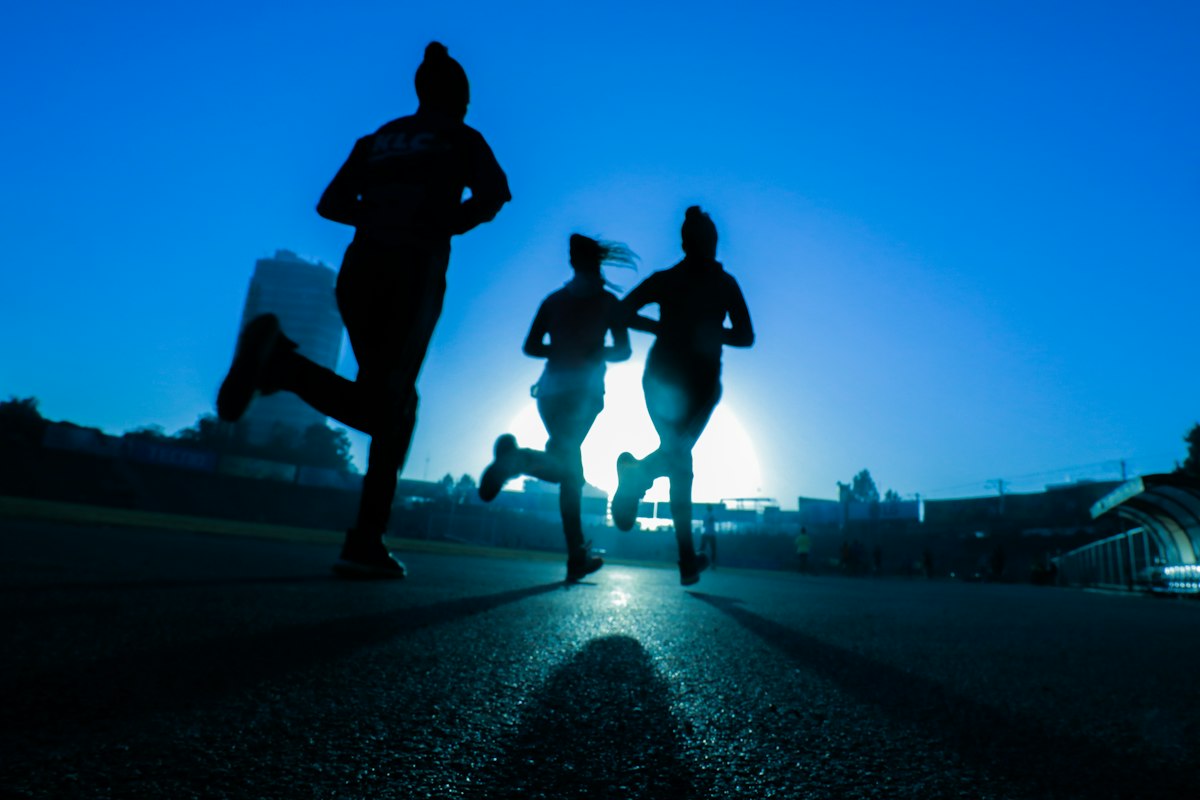 Runners sprinting at dusk
