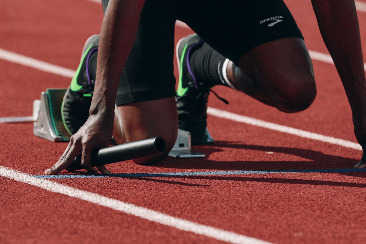 Sprinter set in the starting blocks on a track
