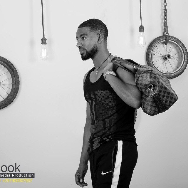 Mesfin Balcha with a gym bag over his shoulder